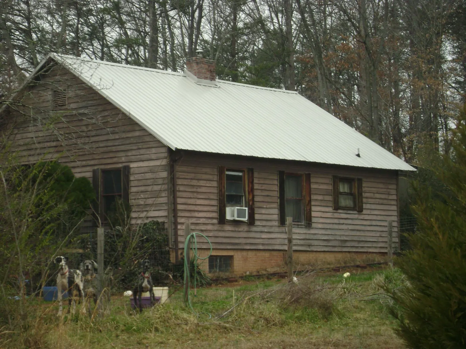 White metal roof on an old wood sided farmhouse, from a Metal Roof Installation job in Lutz